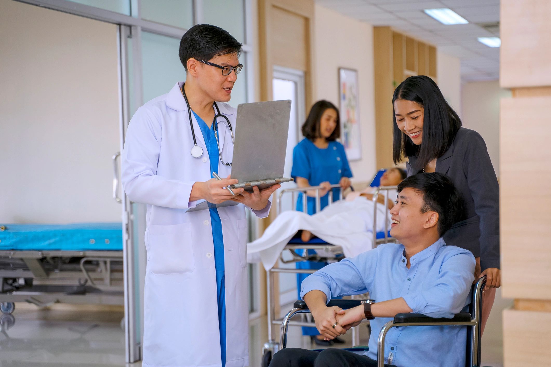 Hospital staff in a patient room preparing for a checkup