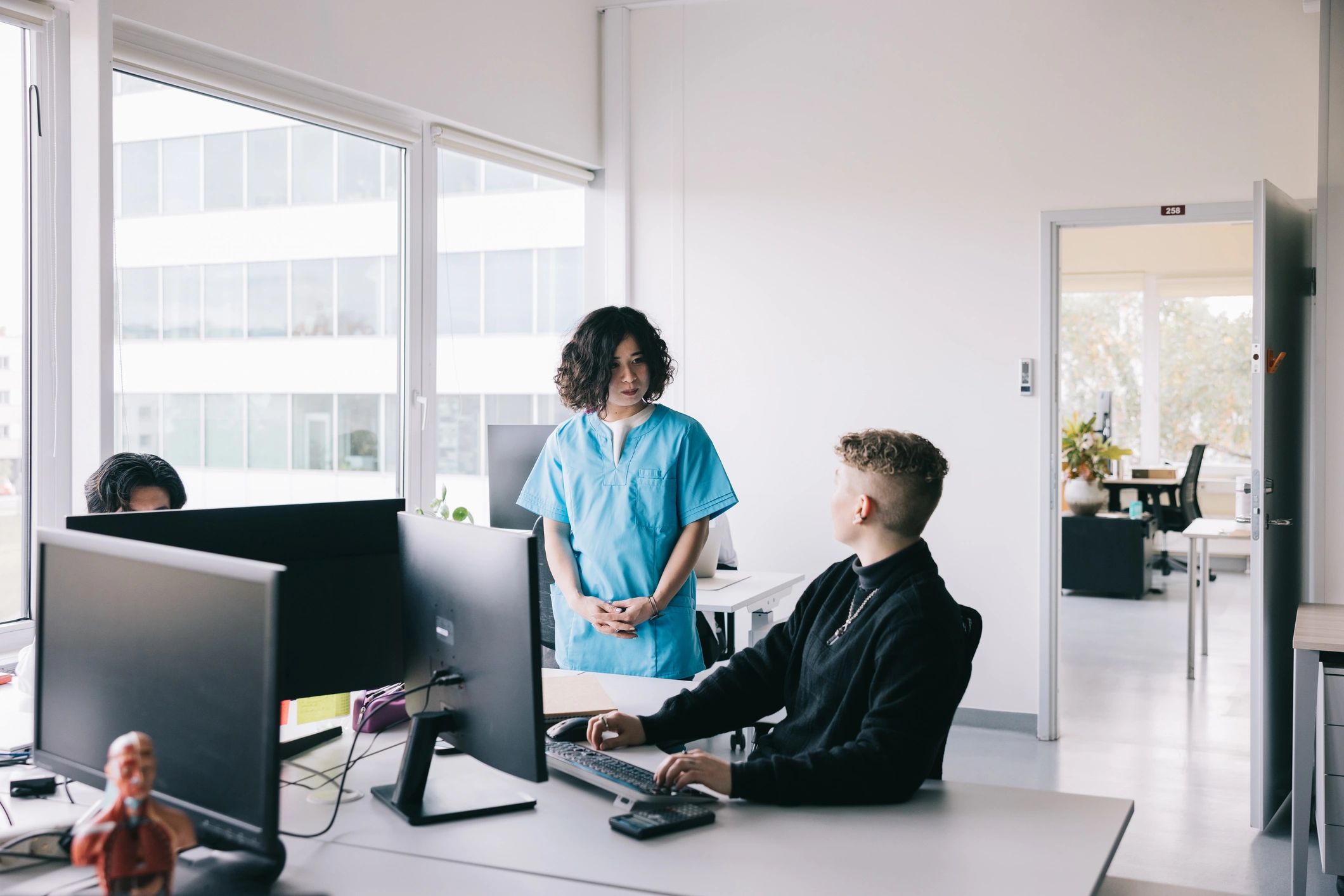 Doctor and medical administrator discussing information in an office
