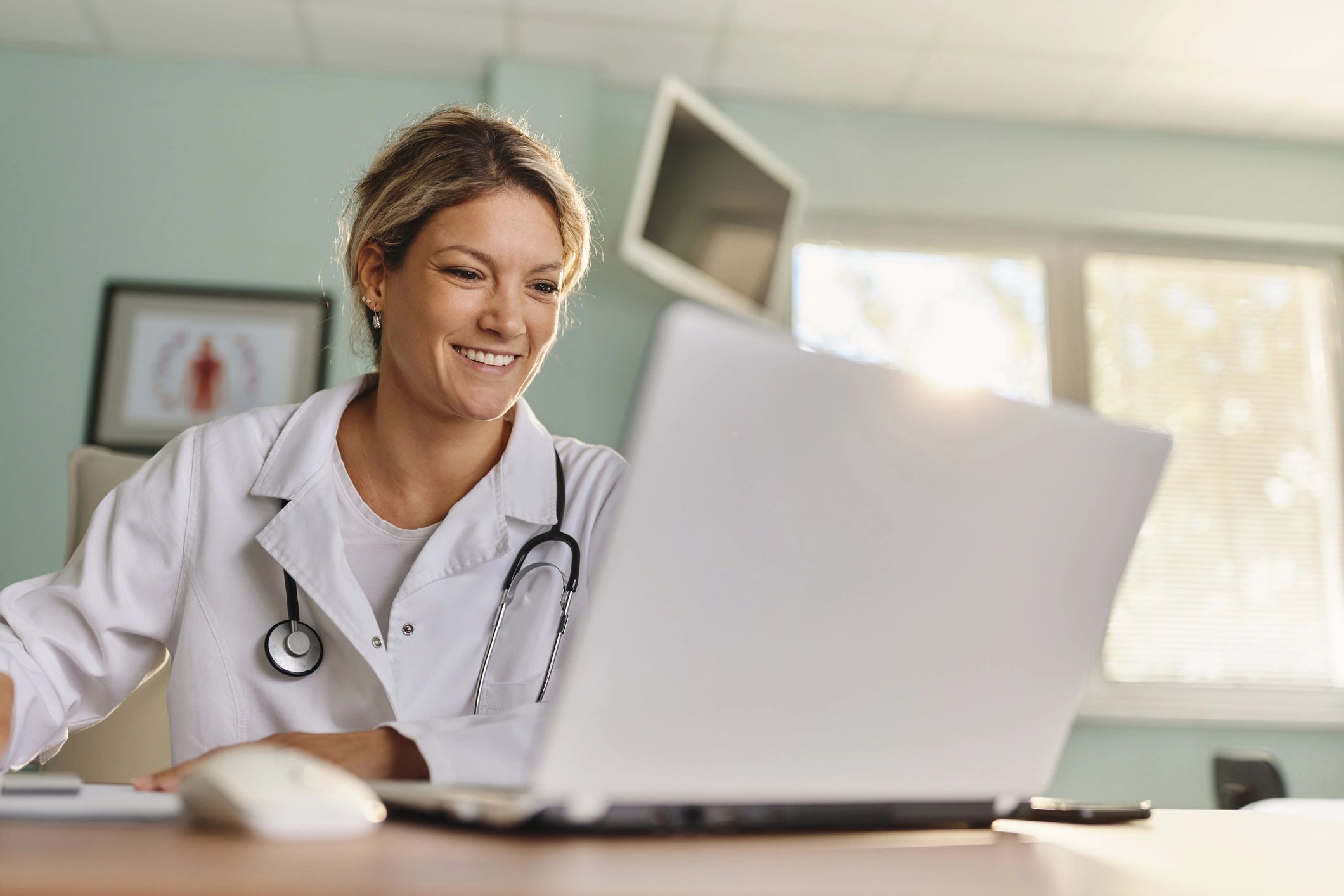 Doctor working on a laptop in an office