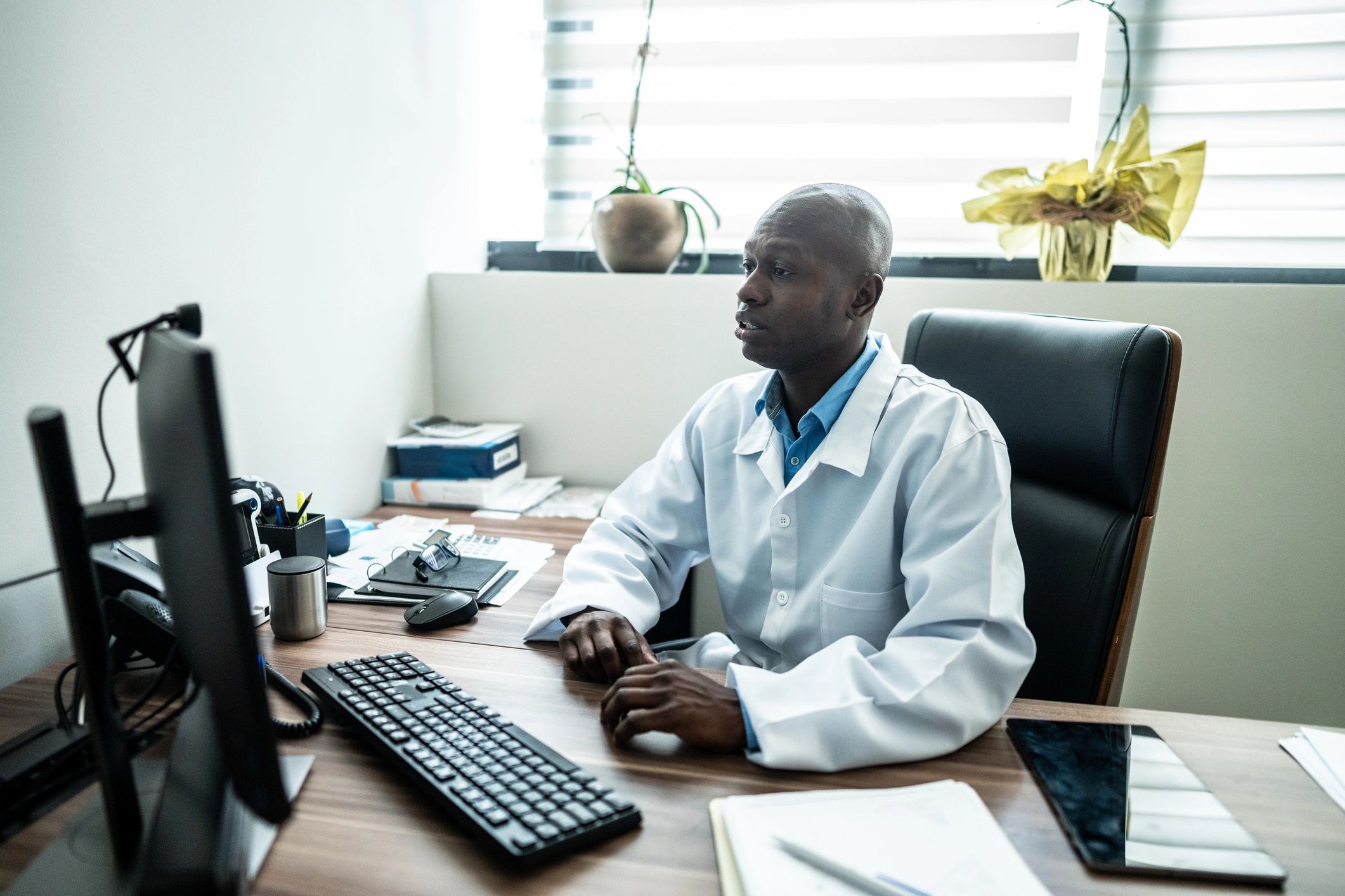 Doctor on a video call using a computer in a medical office
