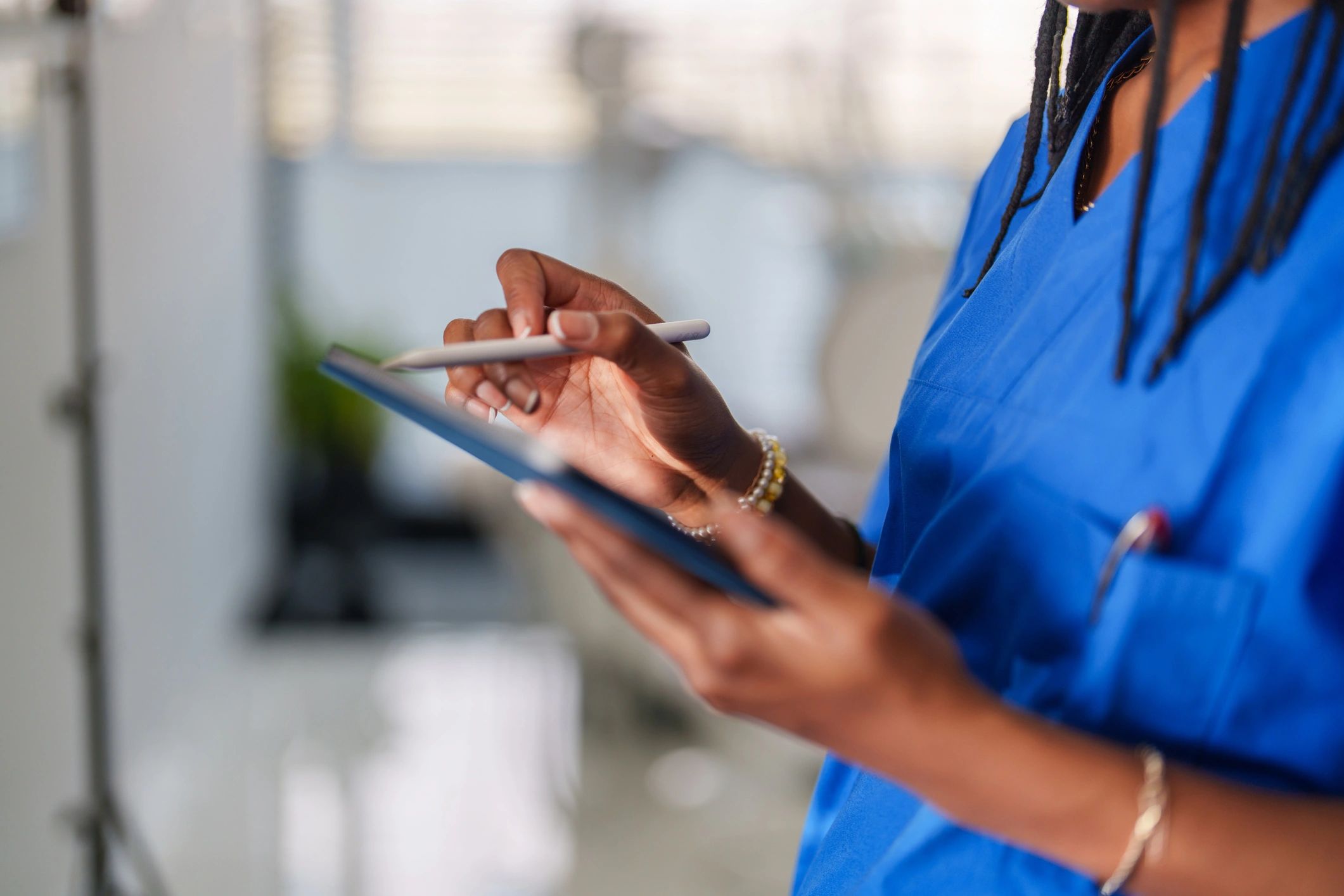 Healthcare worker hands using a digital tablet
