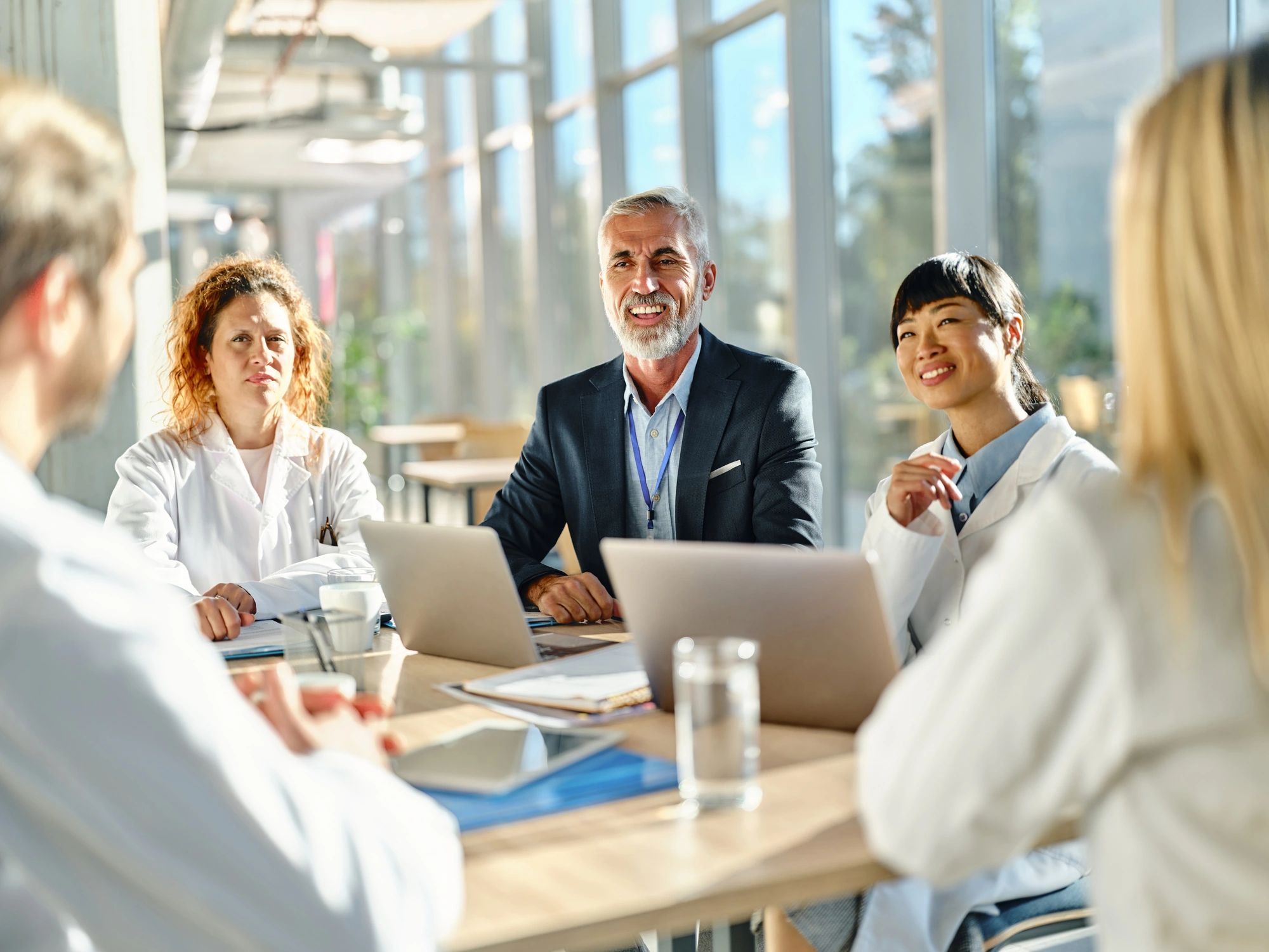 Healthcare team reviewing information on a laptop in a hospital setting