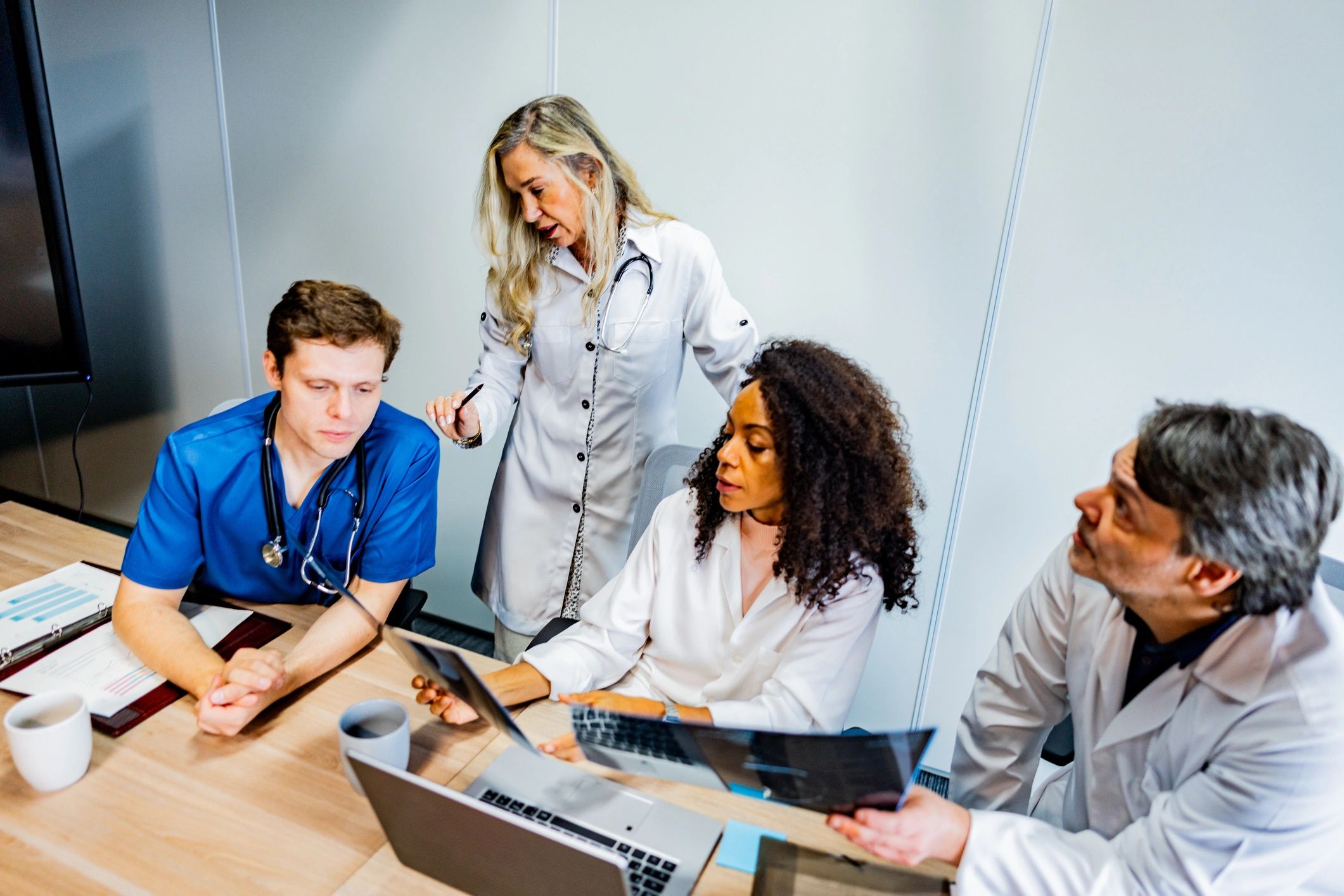 Doctors collaborating in a clinic office while reviewing information on a computer