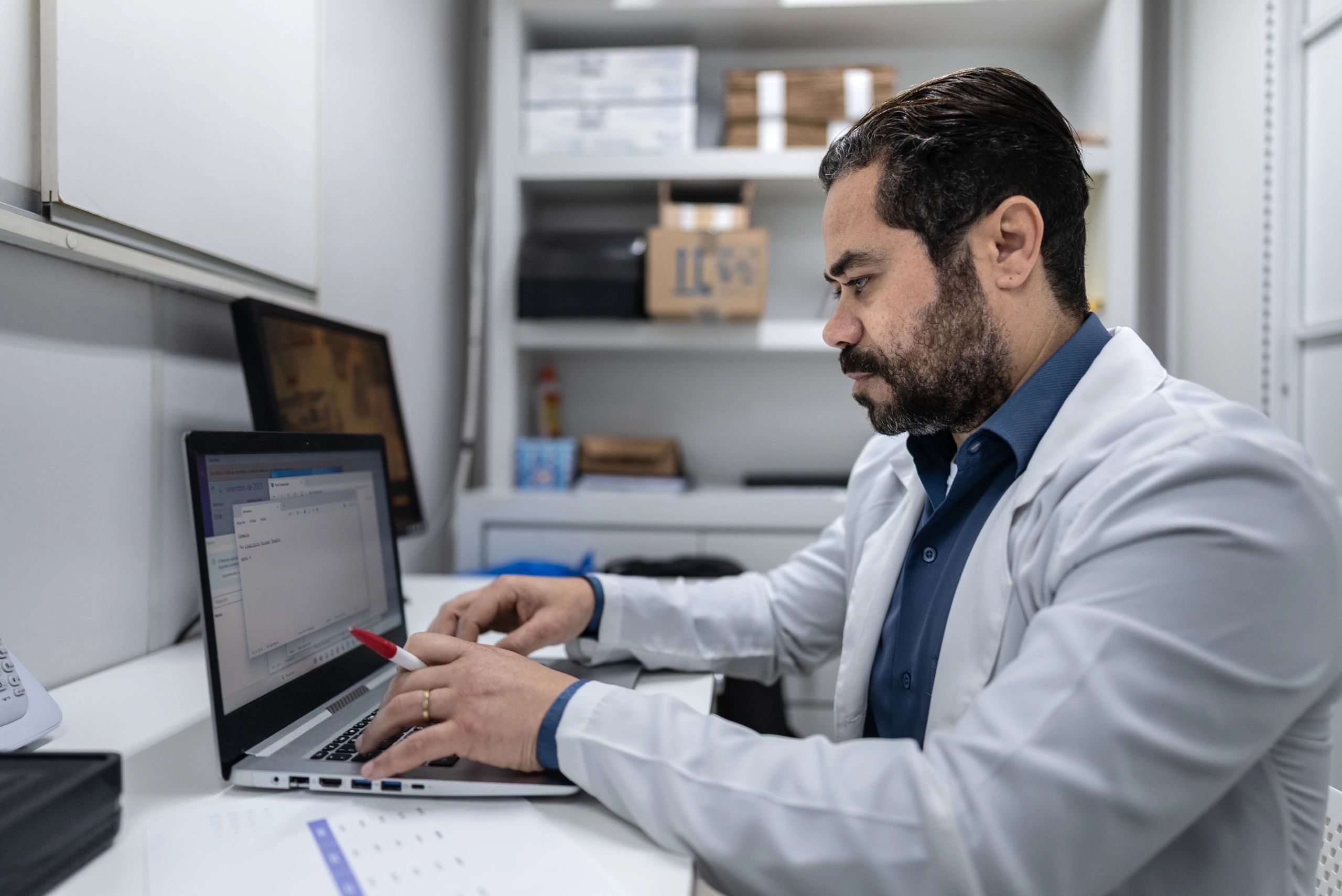 Healthcare professional working on a laptop in an office